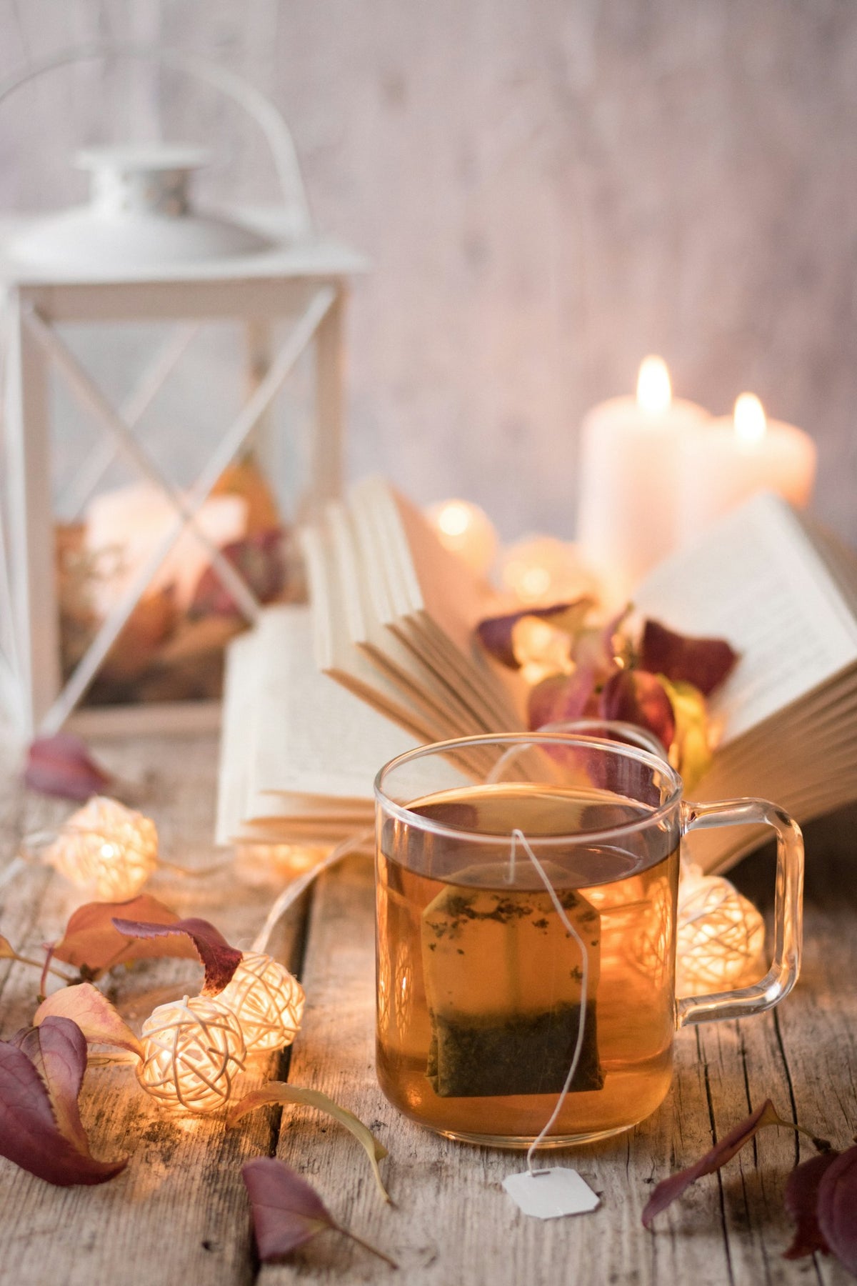 A warm glass of evening tea beside a book — winding down