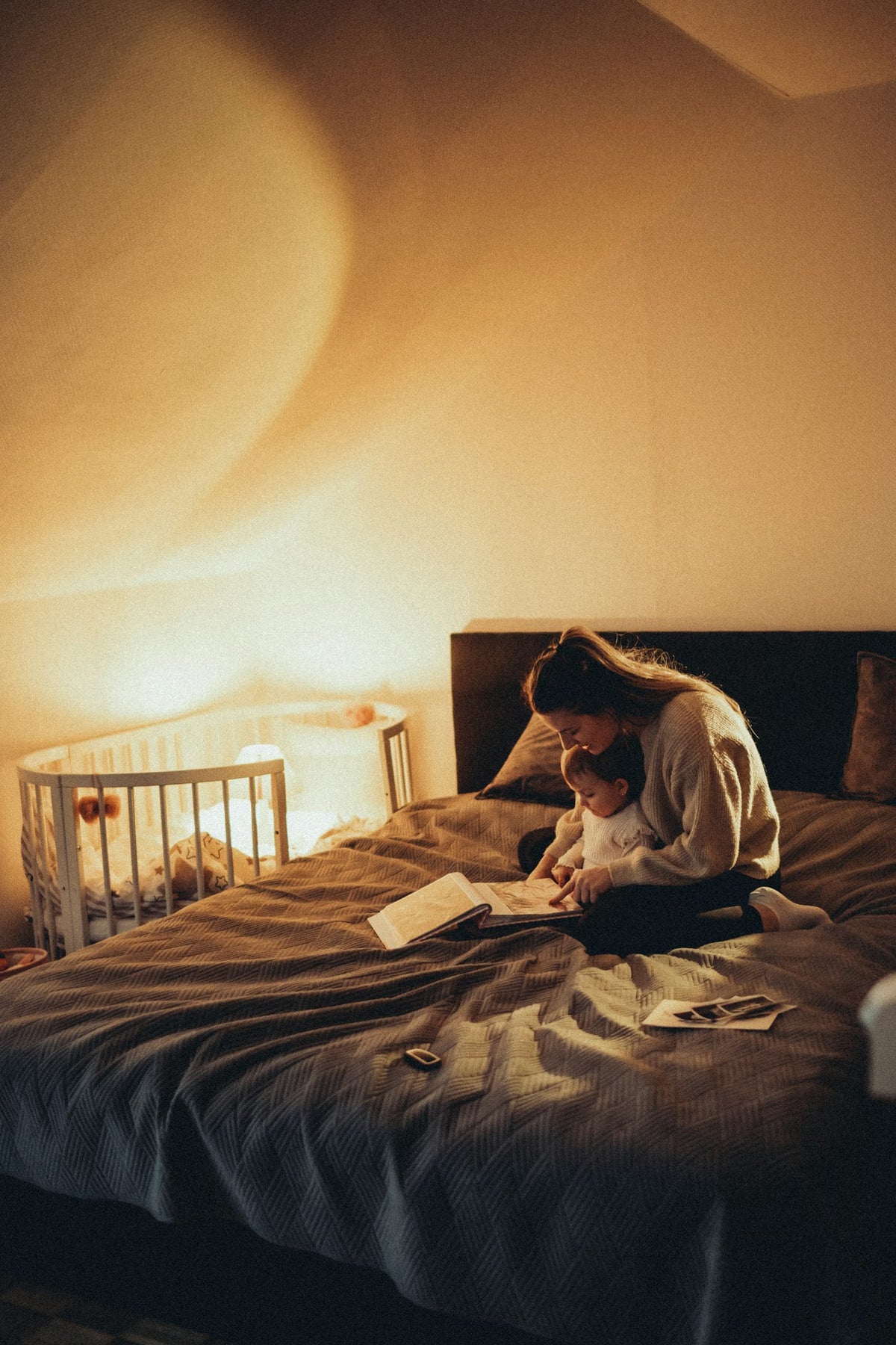 Reading to a little one by lamplight — the quiet hour